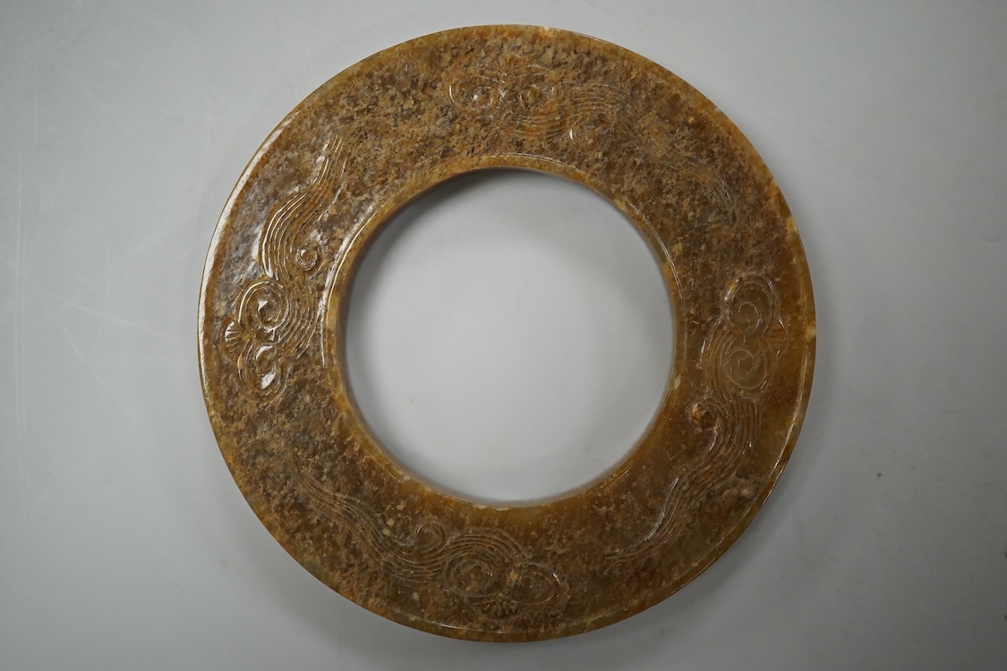 A Chinese russet jade dragon disc, 5.5cm diameter